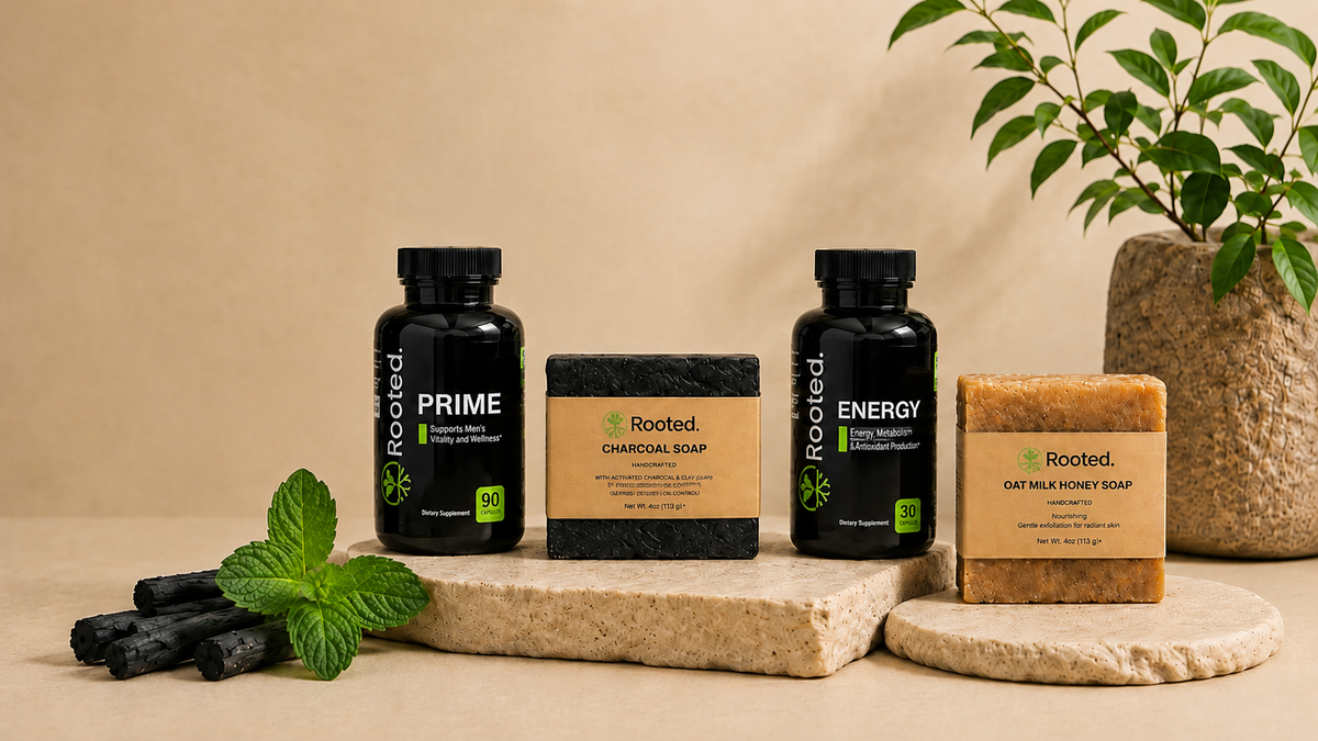 Rooted Essentials Prime, Energy, Charcoal Soap, and Oat Milk Honey Soap displayed on natural stone